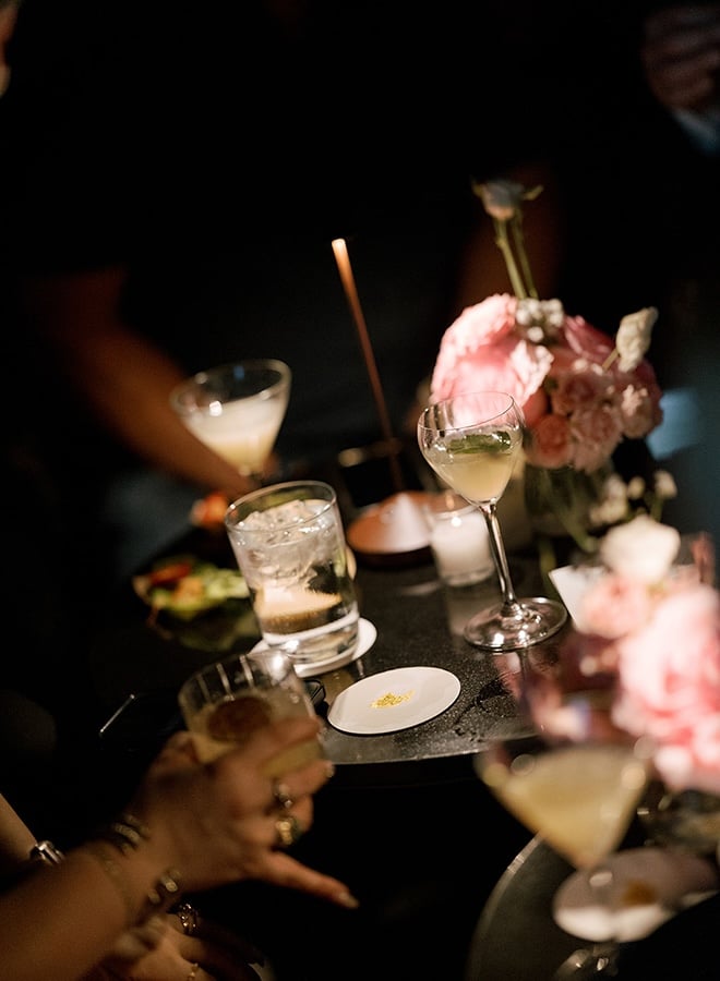 Wedding guests enjoy cocktails at the Houston restaurant wedding reception. 