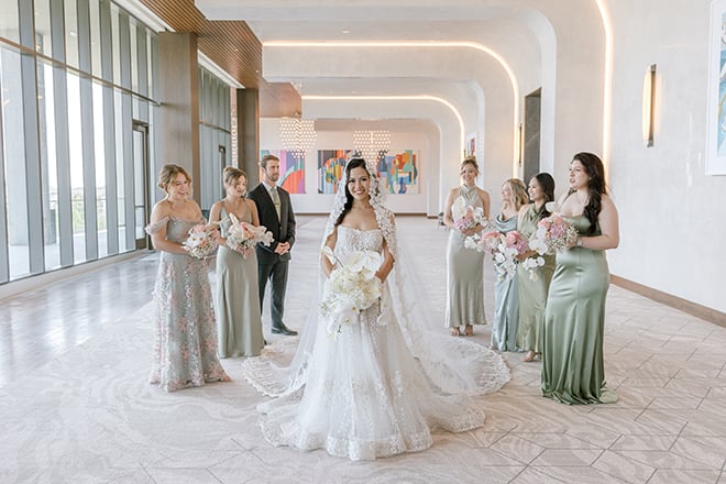 The bride and her bridal party taking portraits at a Houston hotel wedding venue. 