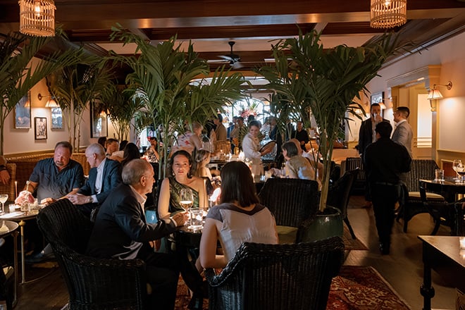 Guests celebrate the newlyweds at a restaurant wedding reception in Houston. 