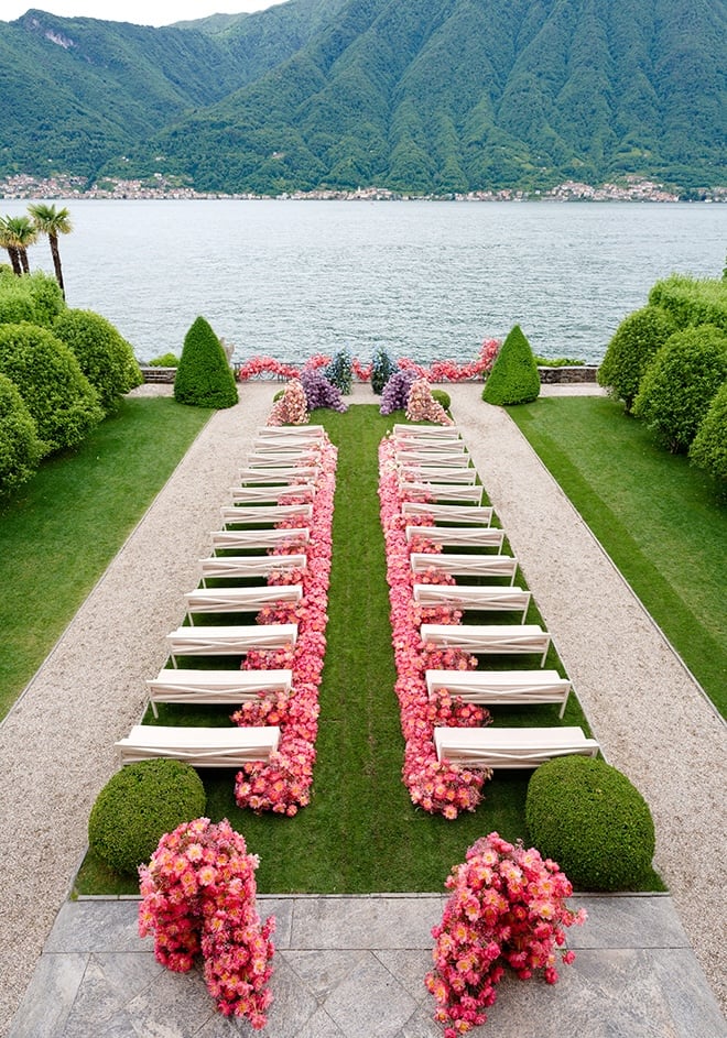 Colorful flowers line the aisle at the al fresco wedding in Lake Como, Italy.