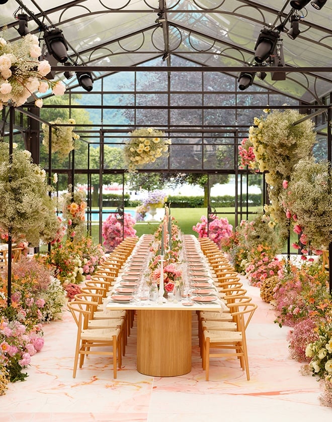 Baby's breath and colorful floral decorate the vibrant al fresco wedding reception.