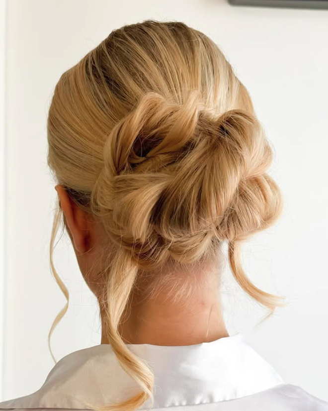 A sleek braided updo by Bridal Beauty Tribe. 