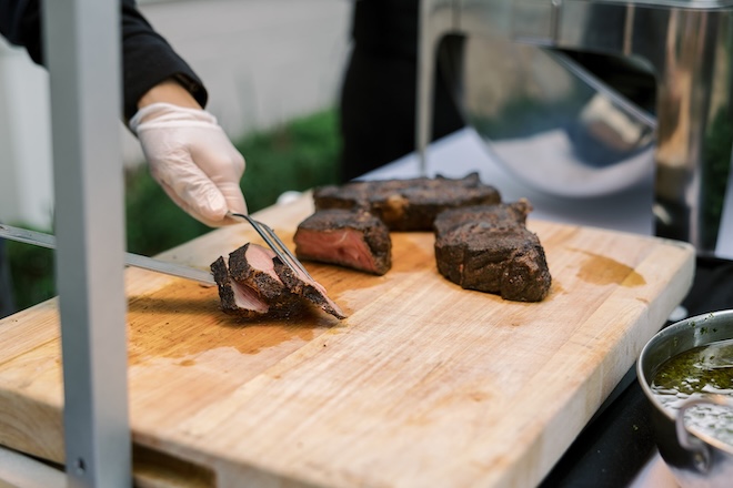 A meat carving station by Café Natalie is at the couple's wedding reception. 