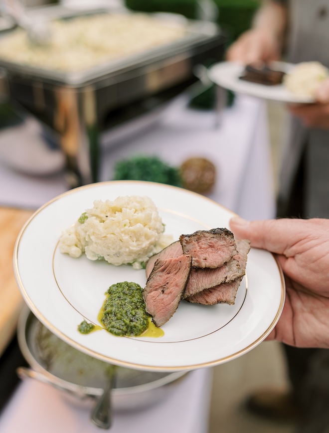 A New York strip, risotto and chimichurri sauce is served at a wedding reception. 