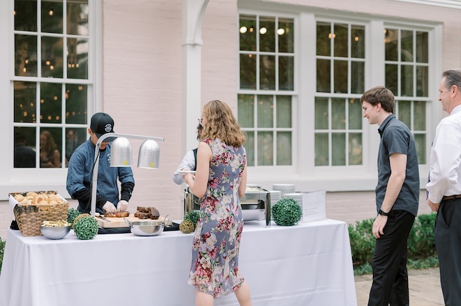 Food stations are served to wedding guests at the outdoor reception. 