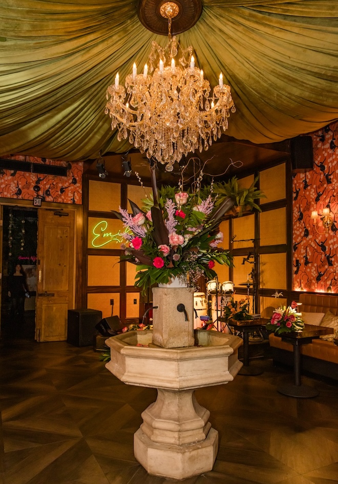 The fountain in Emilia's Havana with tropical florals decorating it.