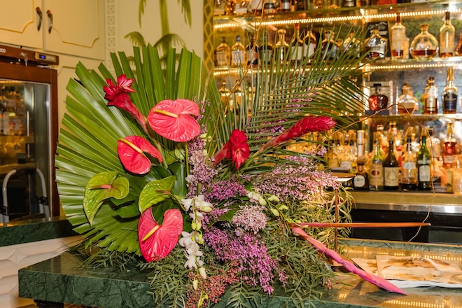 Tropical floral display on the edge of the bar. 