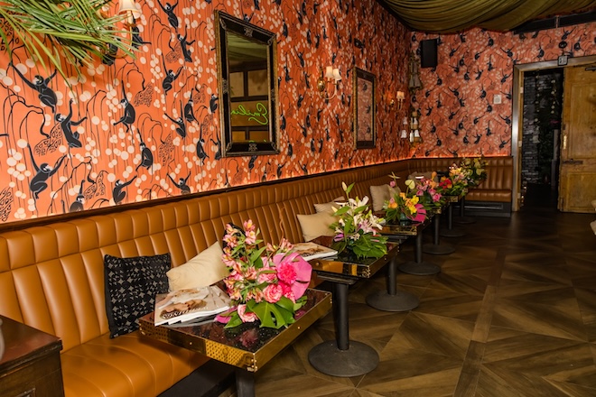 The tables at Emilia's Havana decorated with tropical florals and magazines. 