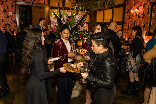 Guests eating passed light bites. 