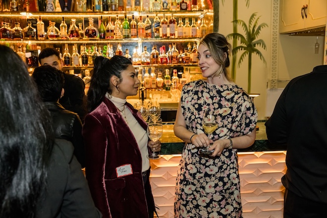 Guests chatting at the bar. 