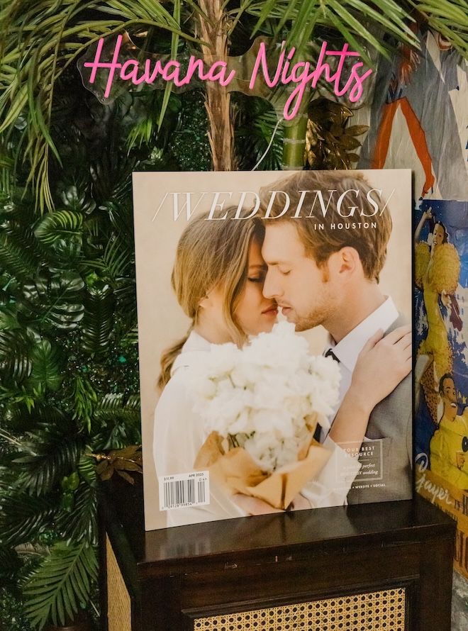 A pink havana nights sign with our April 2025 Weddings in Houston magazine cover. 