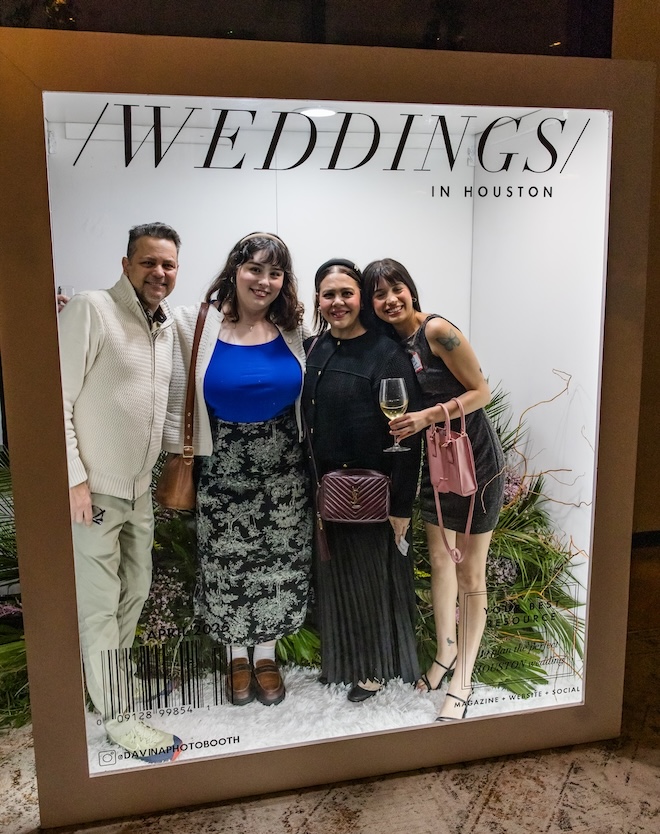 Guests posing in the magazine cover photobooth. 