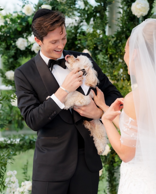 The dog give the groom kisses at their wedding ceremony in Venice, Italy. 